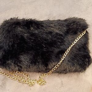 Elegant Black Faux Fur Clutch with Gold Chain.